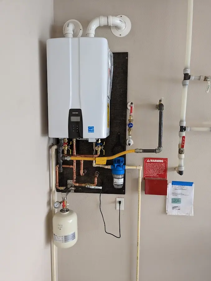 Professional plumber installing copper piping in a Aiken home